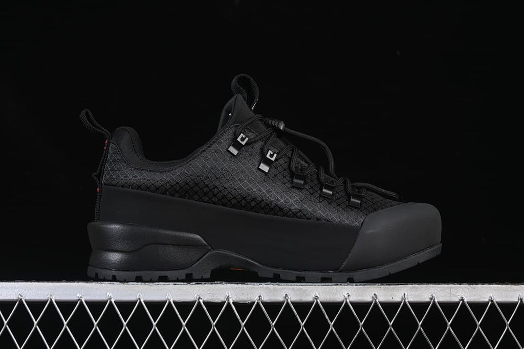 Side profile showing the black upper, toe overlay, and lugged sole.