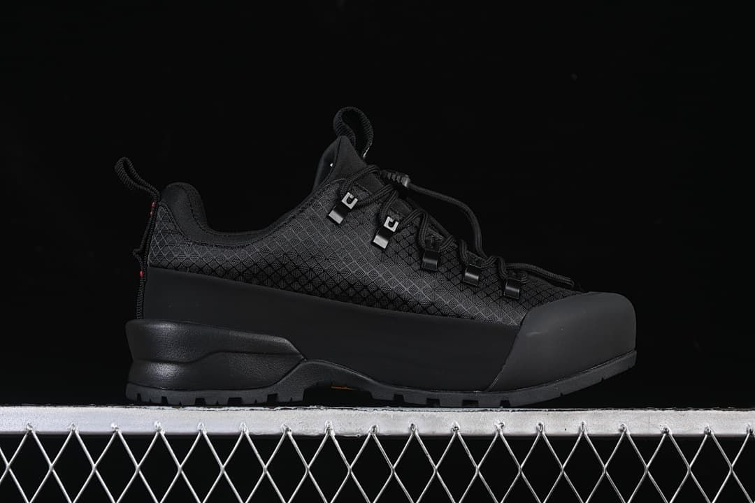 Side profile showing the black upper, toe overlay, and lugged sole.
