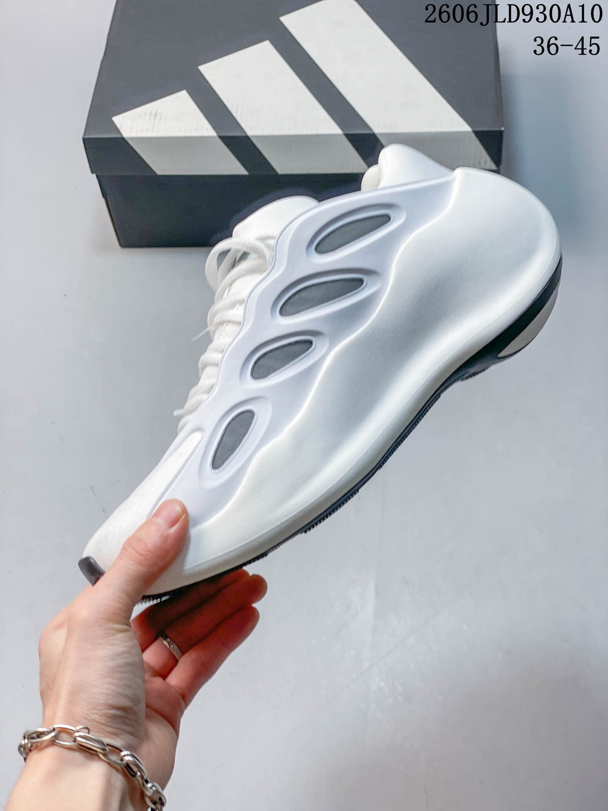 Side view of the white adidas Hyperboost sneaker with gray inset details.
