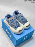 Pair of blue denim Ocai Smile low-top sneakers with oversized laces and white toe bumpers.