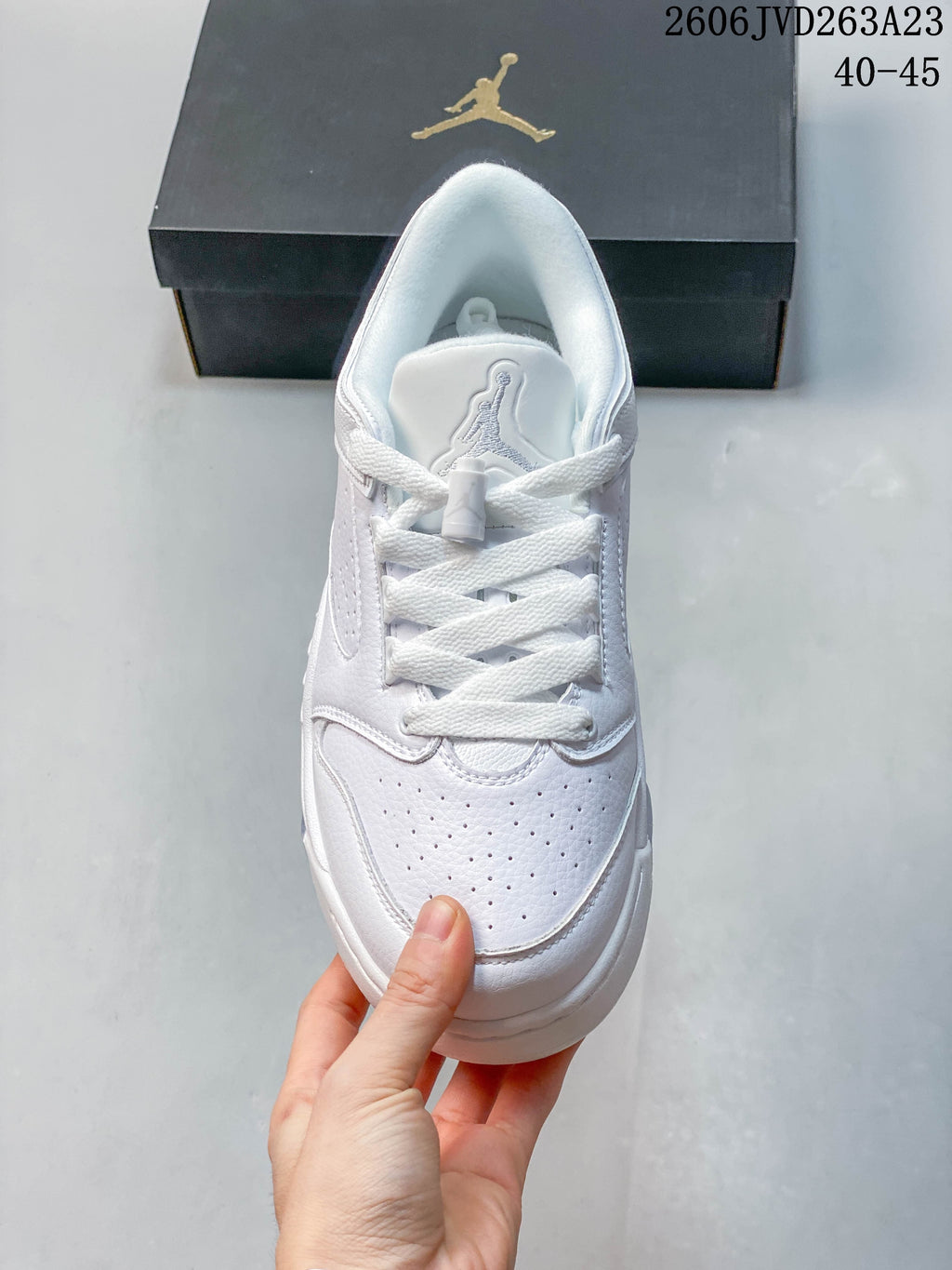 Top view of a white lace-up sneaker with perforated toe panels