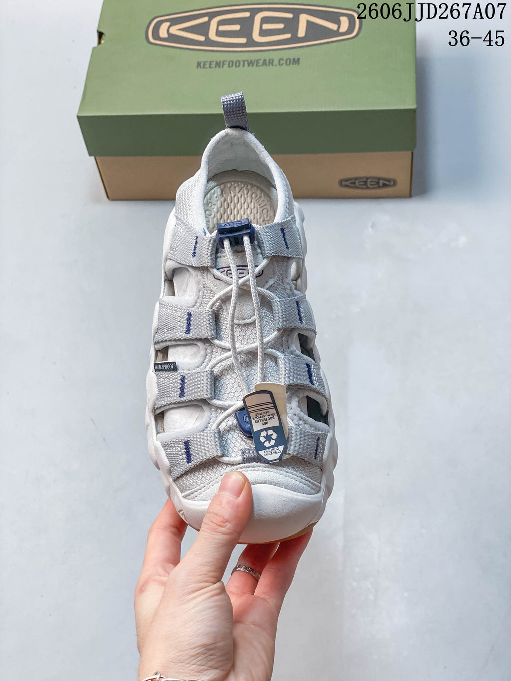 Top view of a sandal showing its cord-and-toggle closure and adjustable straps