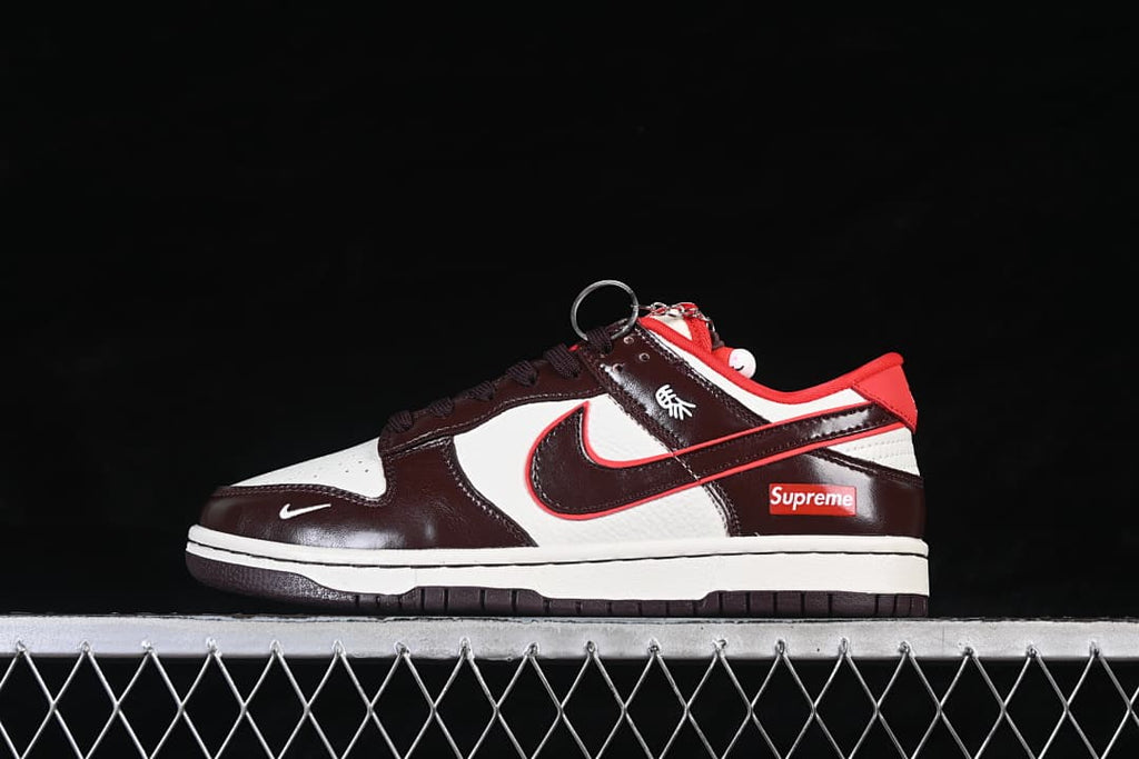 Side view of a brown and white low-top sneaker with red accents