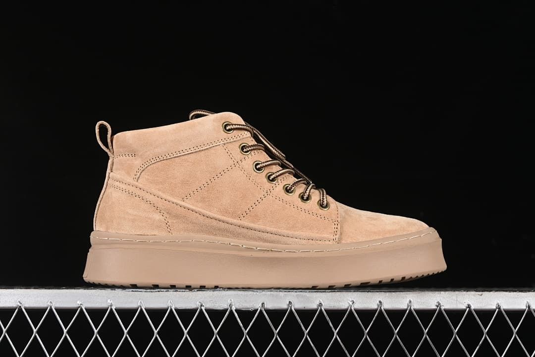 Side profile of the sand-colored mid-top lace-up boot