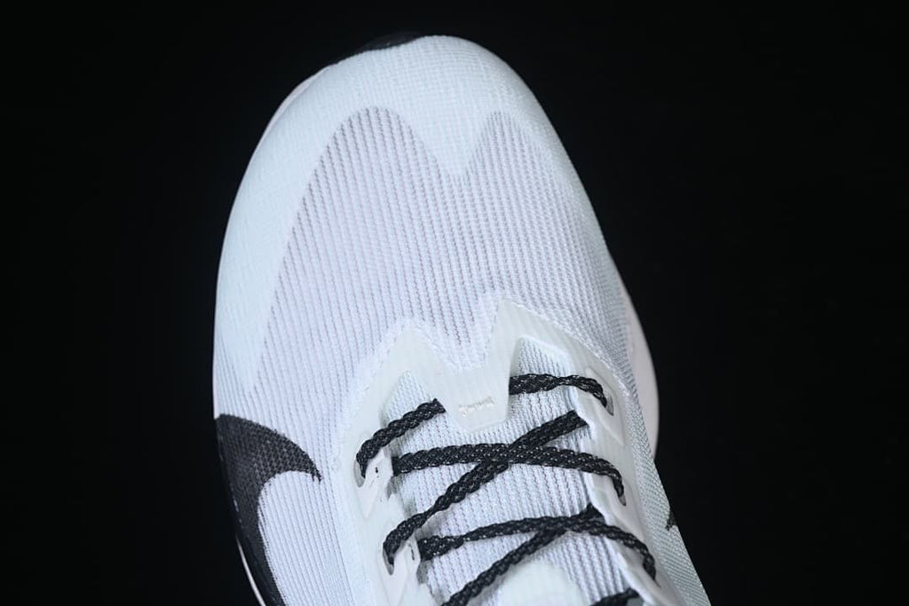 Top-front view of the white running shoe and black laces