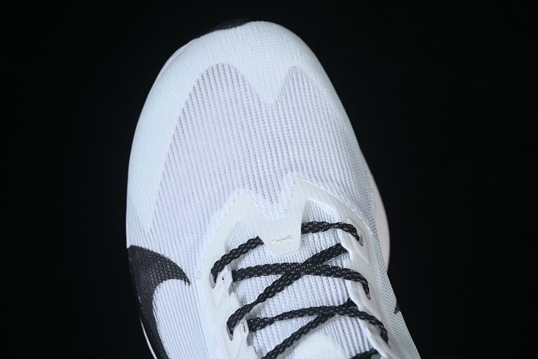 Top-front view of the white running shoe and black laces