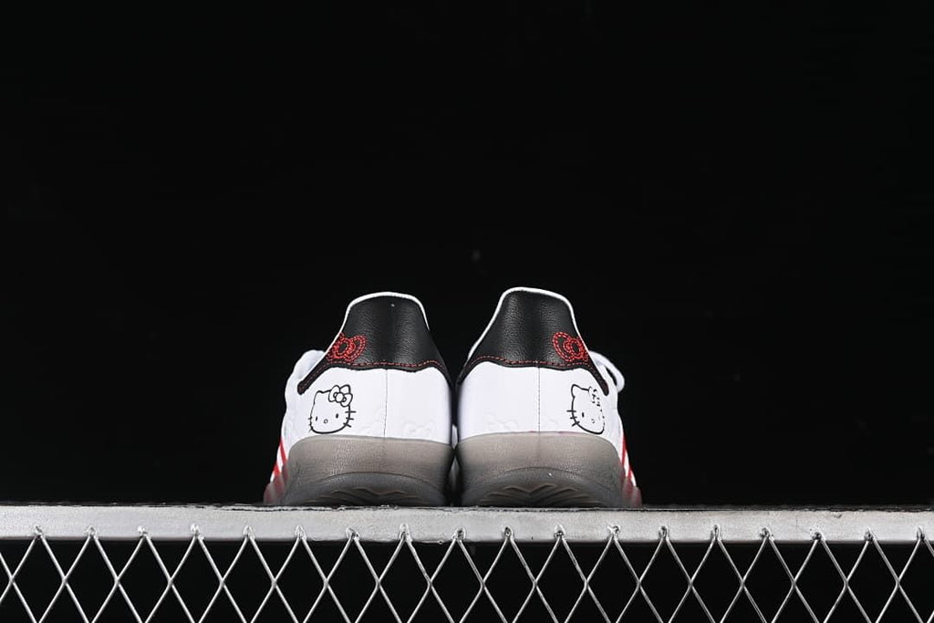 Rear view of both shoes showing Hello Kitty heel graphics and black heel tabs.