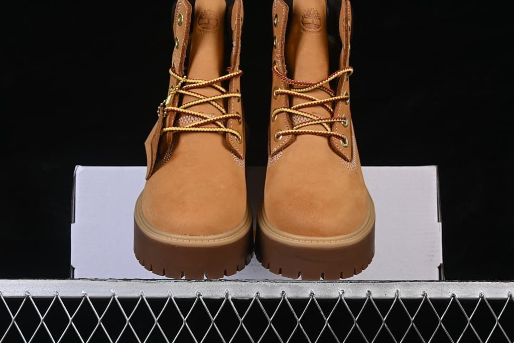 Front view of the pair of boots showing their laces and chunky soles