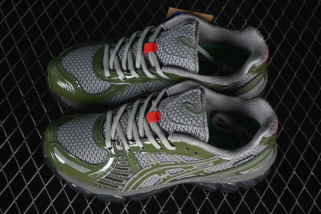 Pair of gray and olive-green ASICS sneakers shown from above.