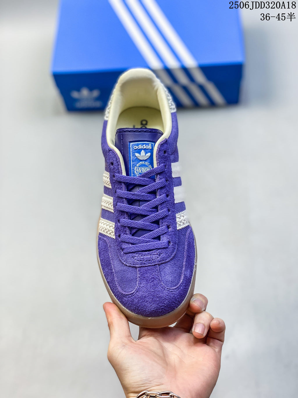 Front view of the purple lace-up sneaker with cream-colored stripes.