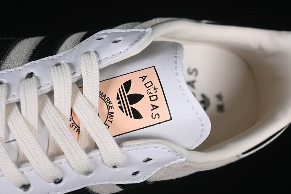 Close-up of tongue label and white laces