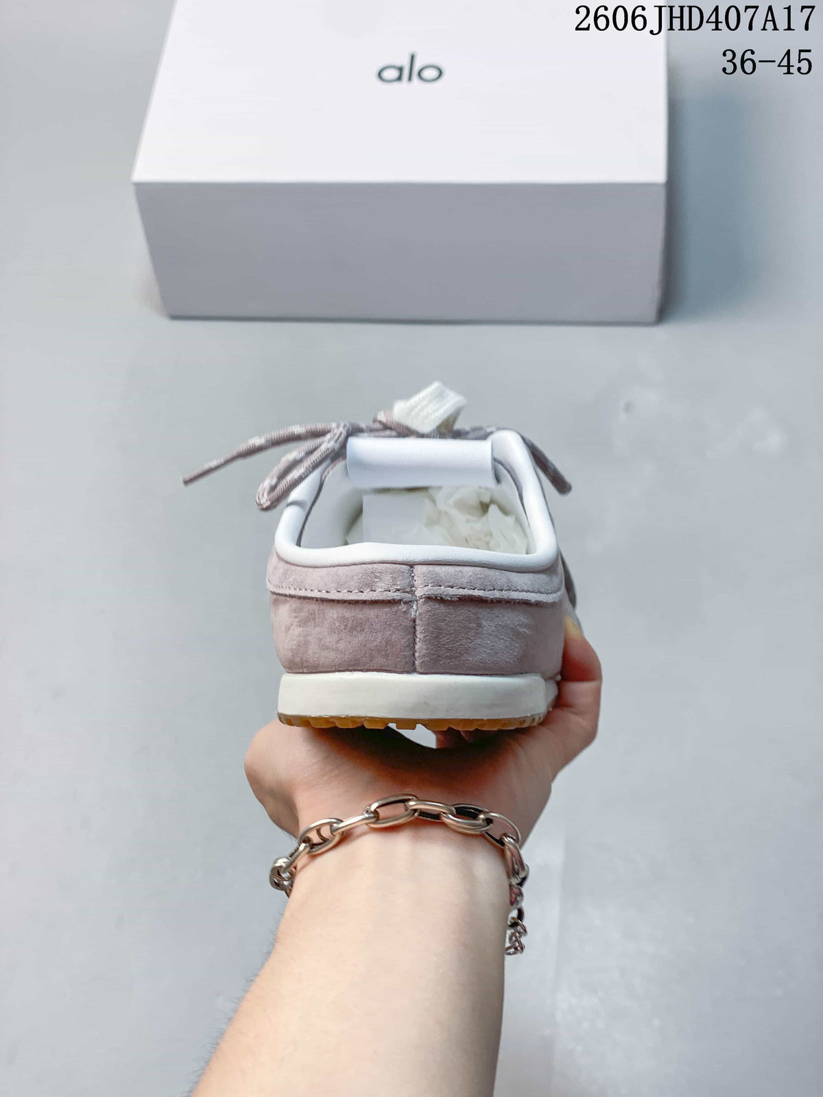 Rear view of the mauve sneaker with white heel trim