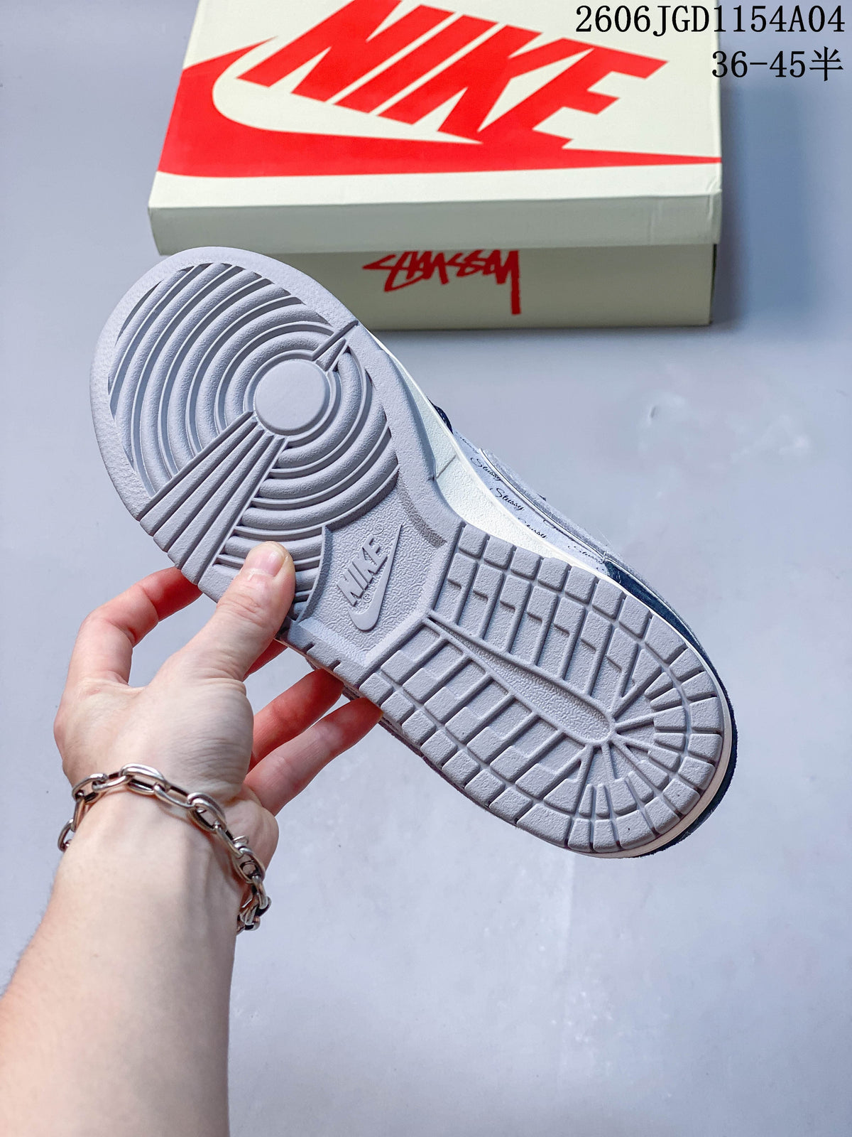 Grey outsole of a blue and grey low-top sneaker