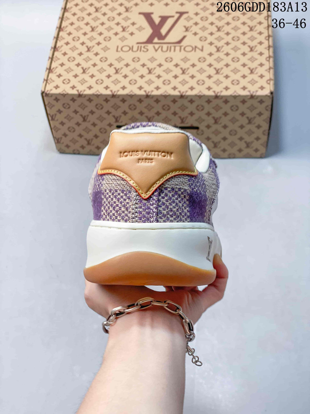 Rear view showing the check-patterned heel, tan heel tab, and white midsole
