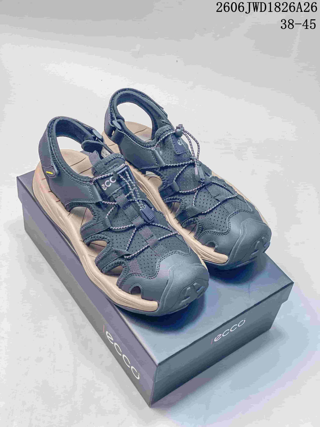 Pair of dark gray ECCO open-toe sandals with perforated uppers, cutout sides, and cord-style front closures.