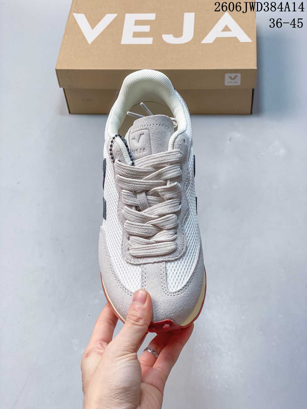 Front view showing the laces, mesh panels and gray toe overlay of a Veja sneaker
