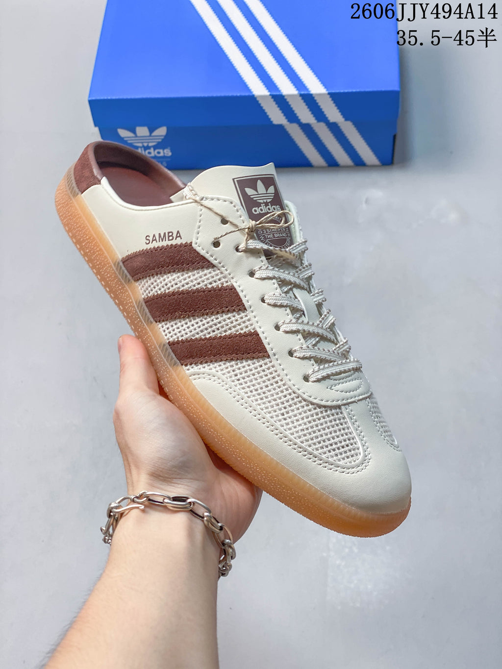 Angled view highlighting the open heel, brown stripes, and gum-colored sole.