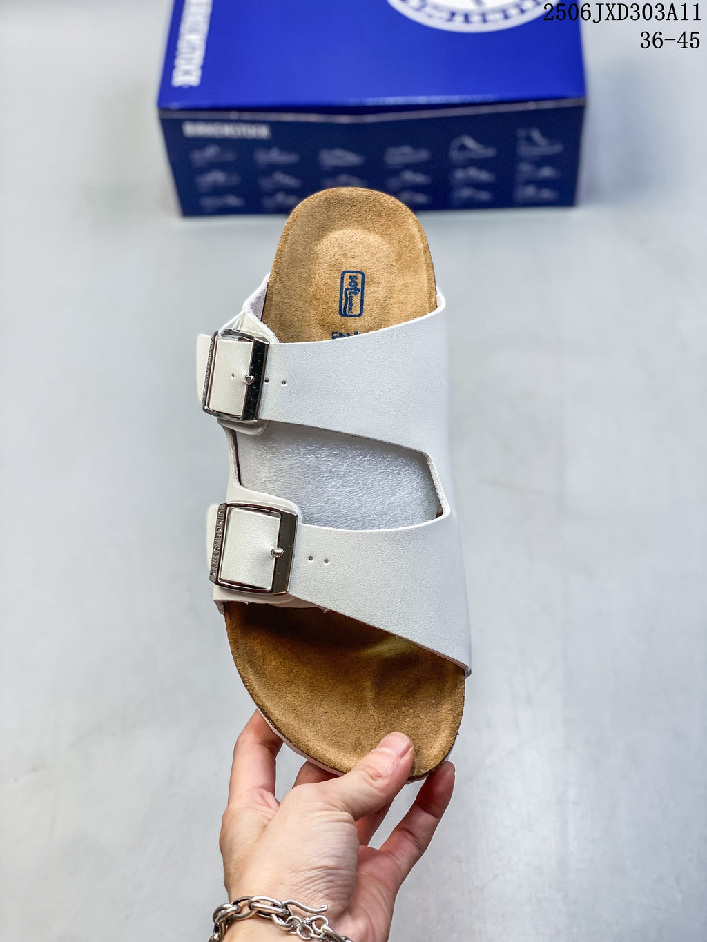 Top view of a white slide sandal with two adjustable buckles and a contoured brown footbed.