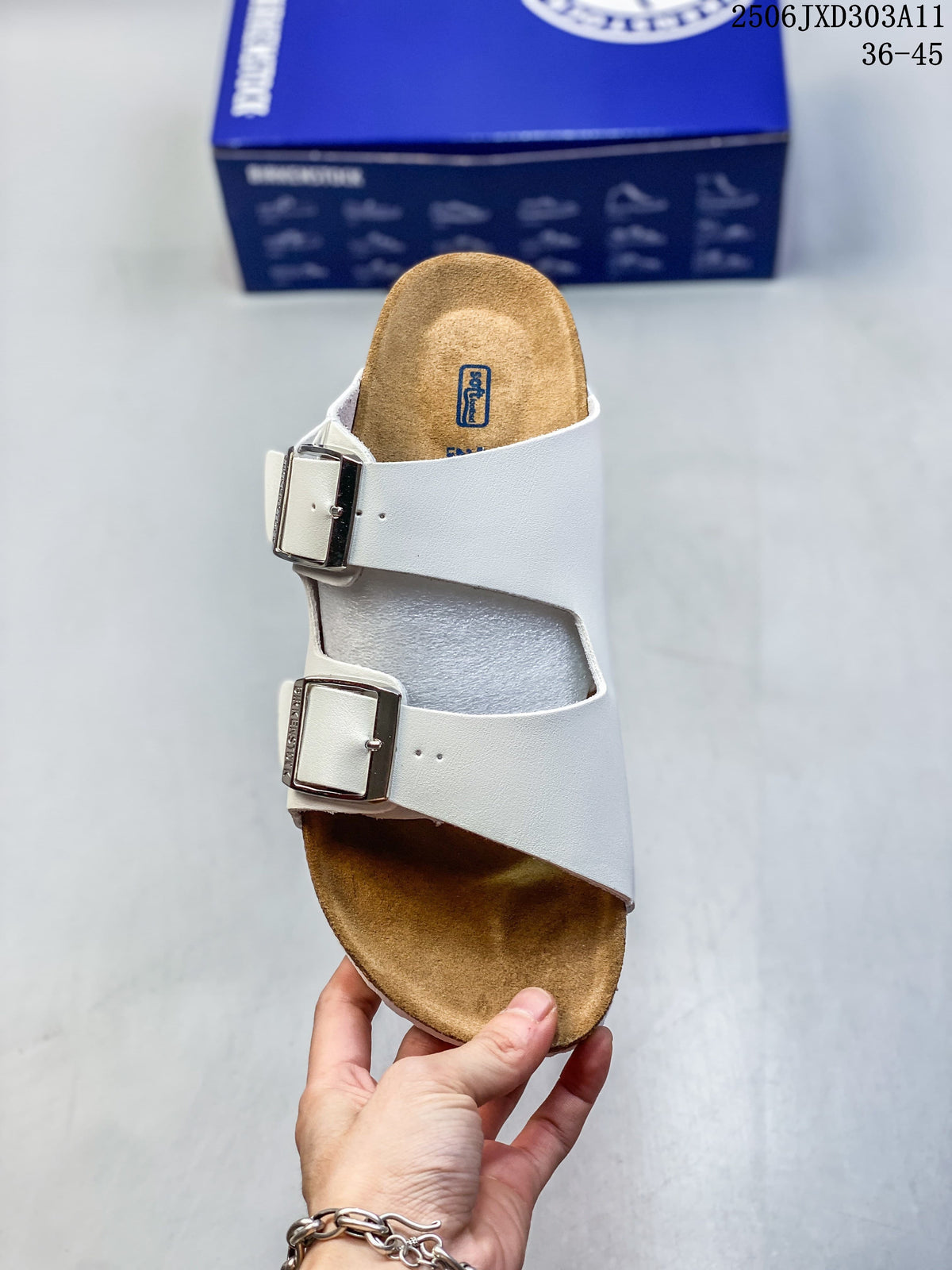 Top view of a white slide sandal with two adjustable buckles and a contoured brown footbed.