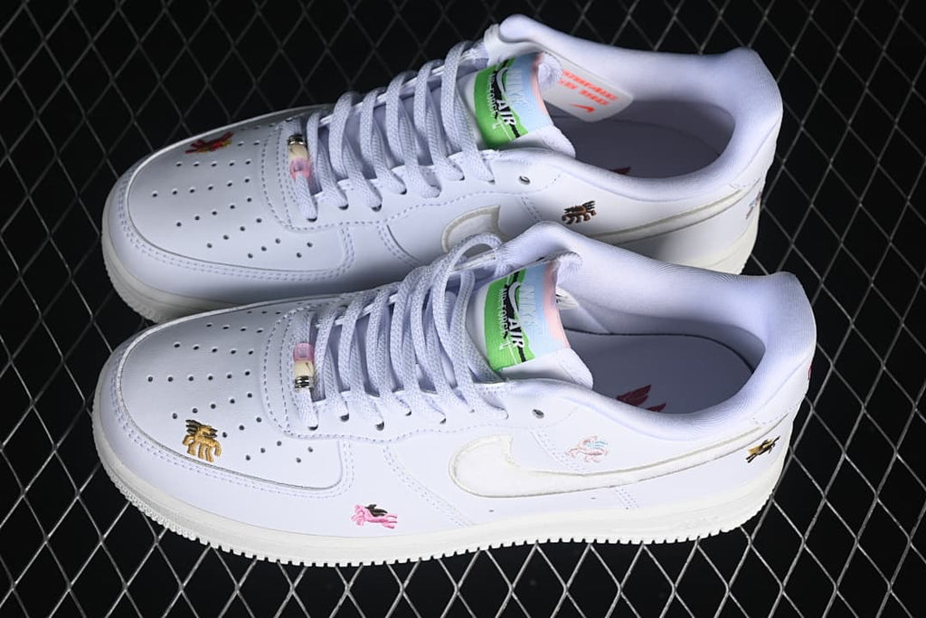 Pair of white low-top sneakers with horse embroidery, shown from above.