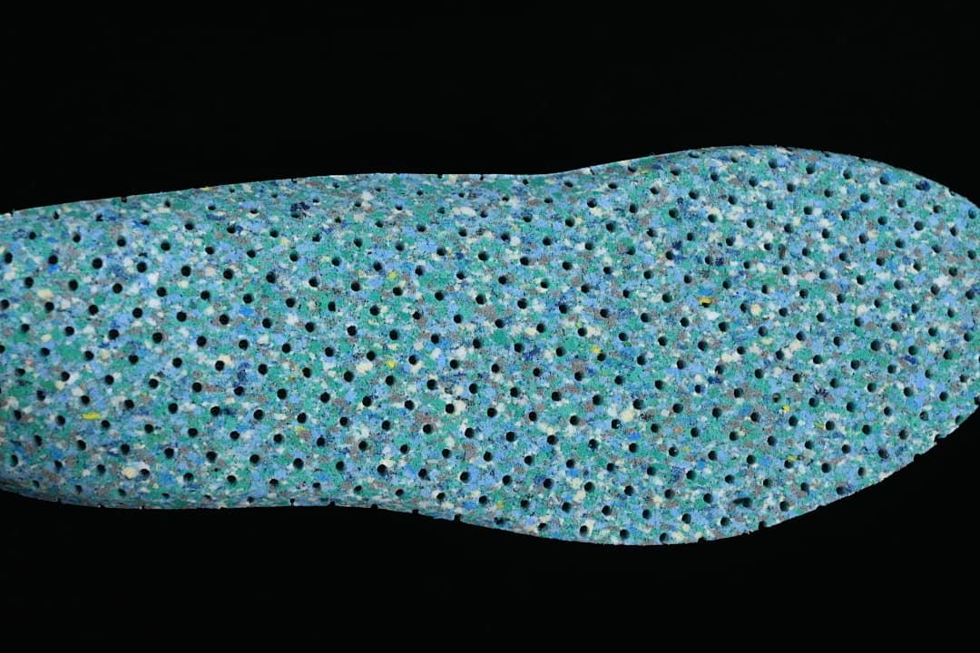 Close-up view of a blue-green patterned shoe insole.