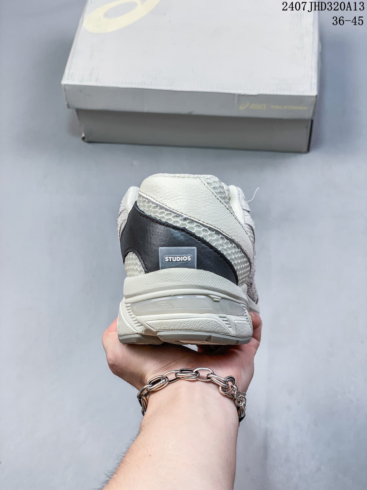 Rear view of the cream and gray sneaker with a dark heel accent