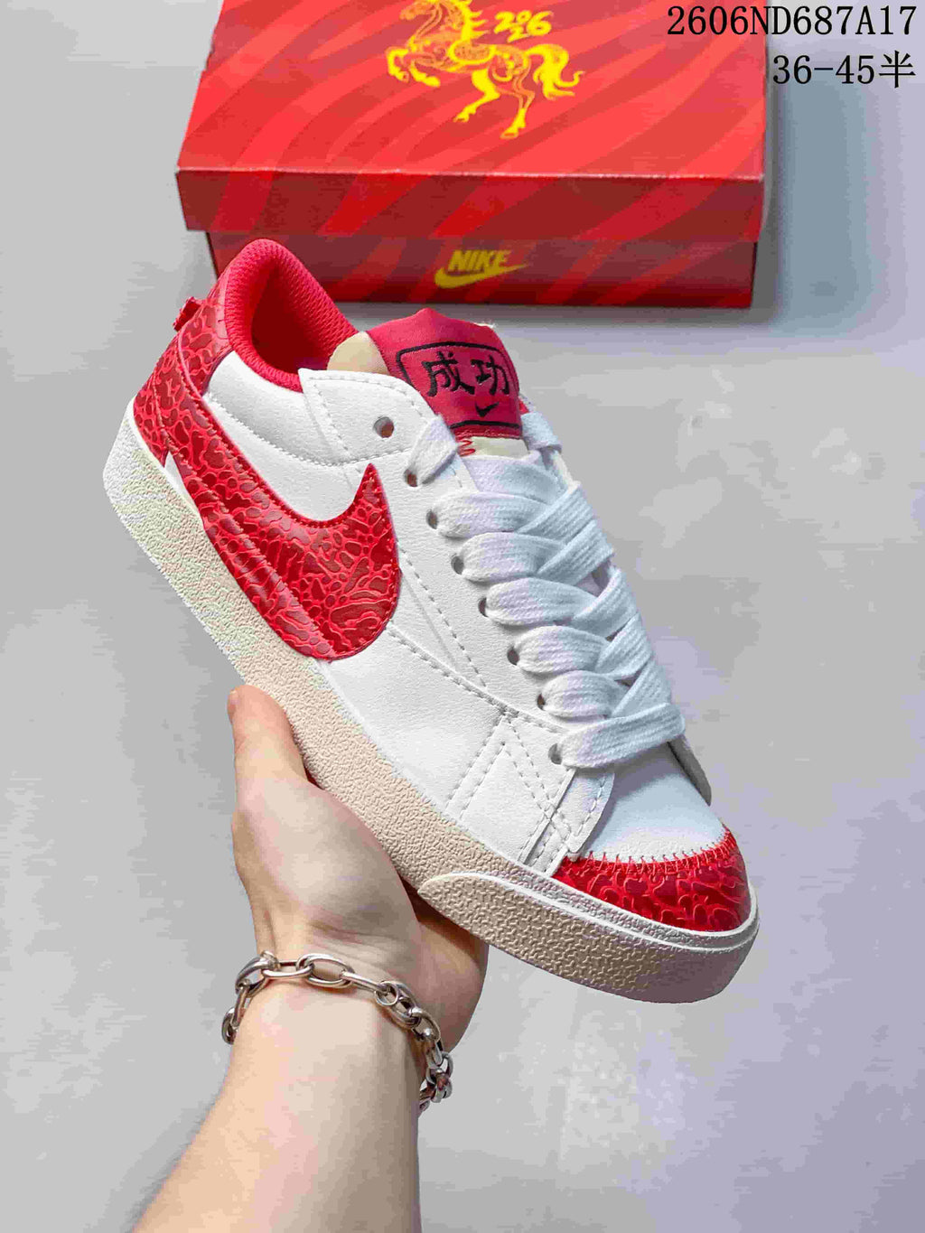Angled close-up of the white and red Nike Court Royale AC sneaker.