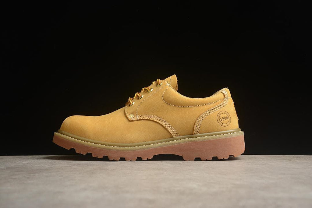Side profile of the Boston yellow low-top shoe against a dark background