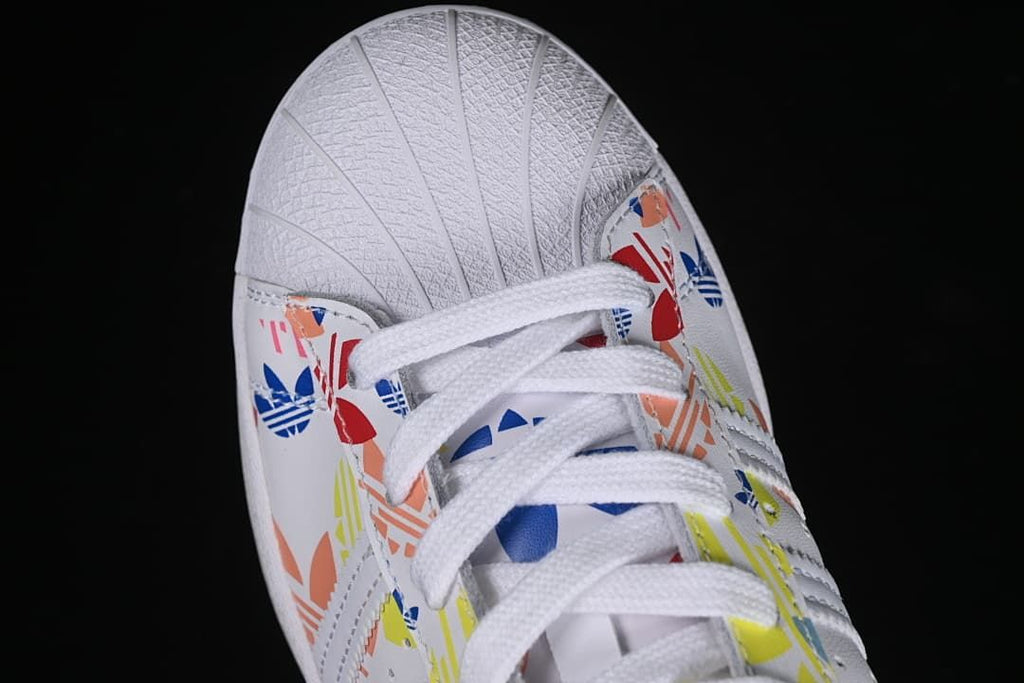 Top view of the shell toe, laces, and colorful graphic panels