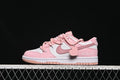 Side view of pink and white Nike Dunk Low sneakers with a heart charm and fuzzy heel detail.
