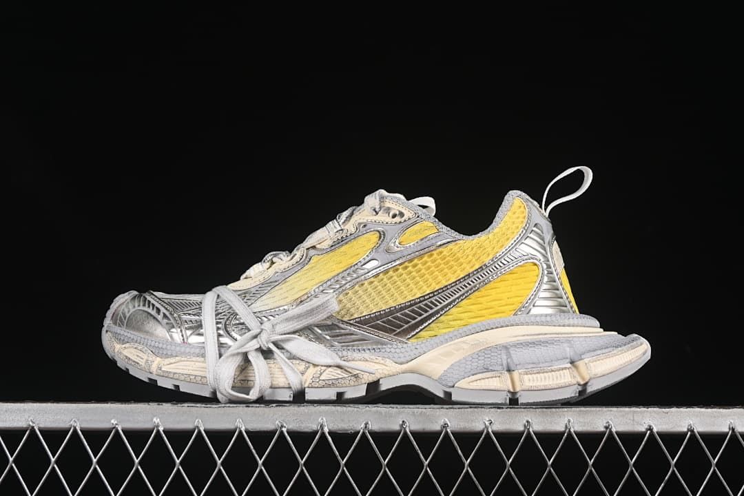 Pair of yellow, off-white, and gray sneakers shown from the side