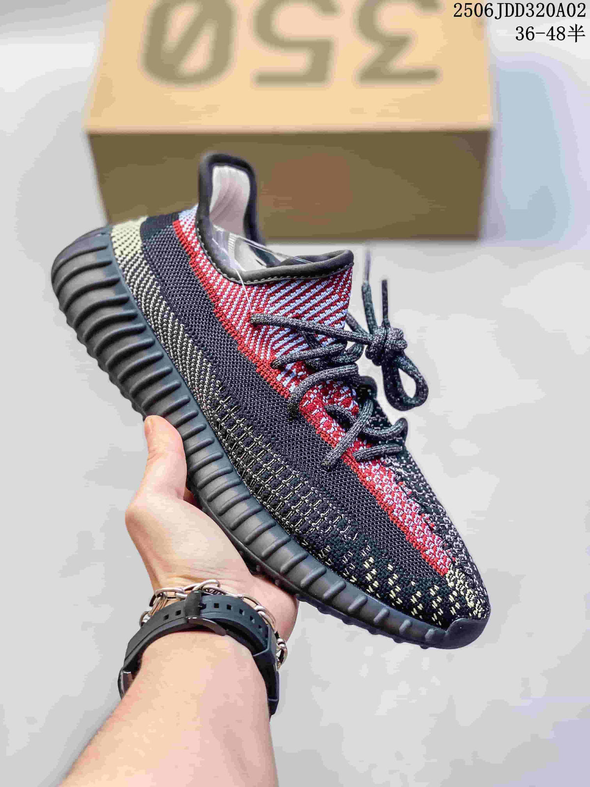 Black, gray, and red knit-look Adidas Yeezy-style sneaker with a ribbed dark sole