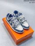 Pair of blue and cream patterned low-top sneakers with layered white laces on an orange box