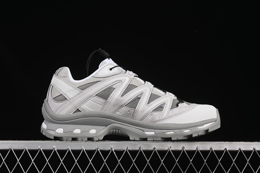 Outer side profile of a gray and white sneaker