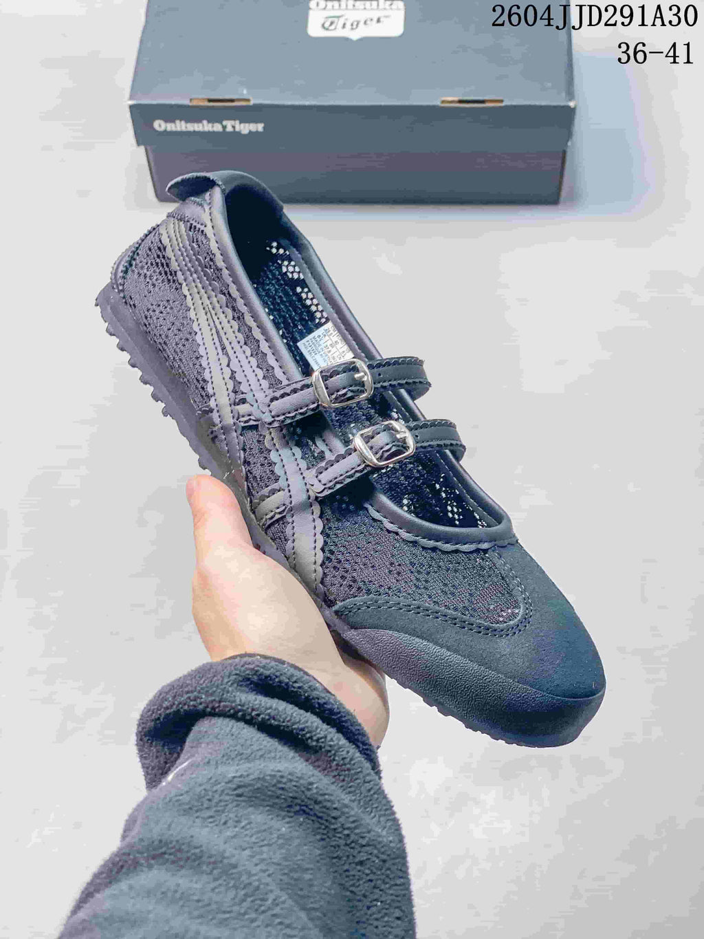 Dark gray Mary Jane-style shoe with two buckle straps, shown beside a box