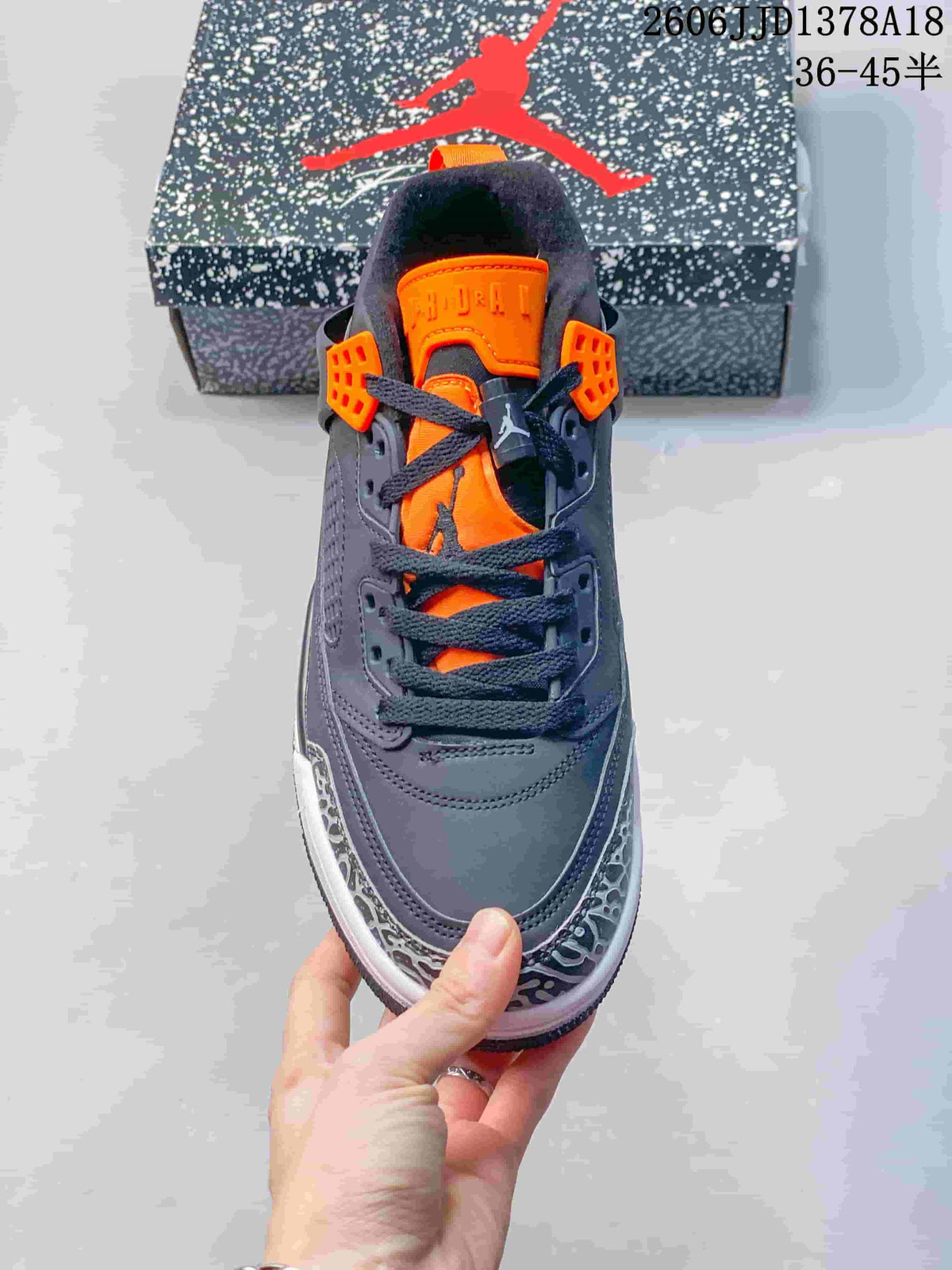 Top view of the sneaker with orange tongue and lace accents.