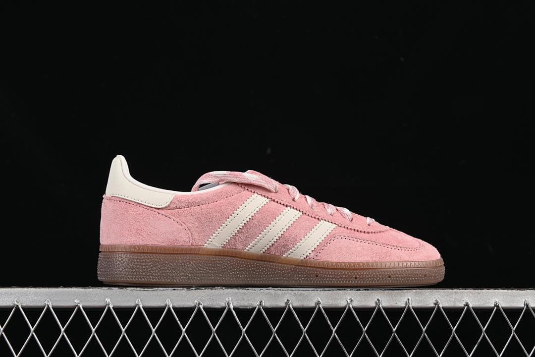 Side profile highlighting the pink upper, off-white stripes, and gum outsole