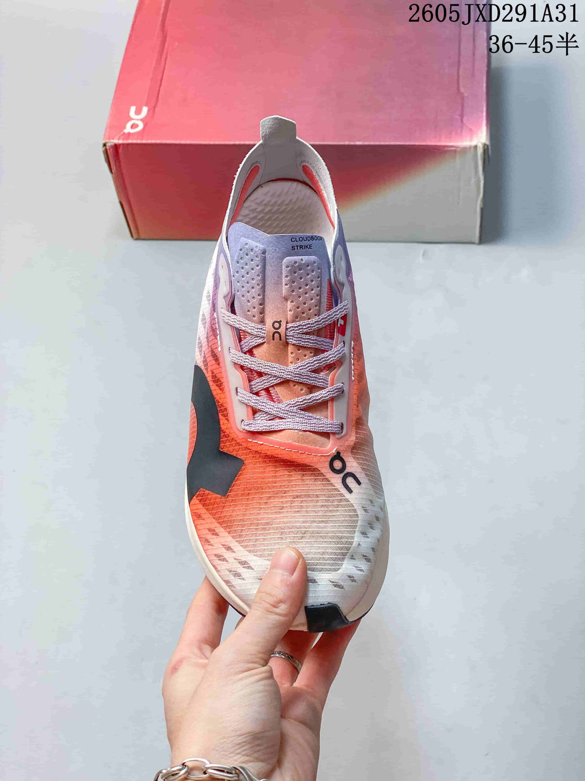 Top view of an On Cloudboom Strike shoe showing the lace-up front and patterned upper.