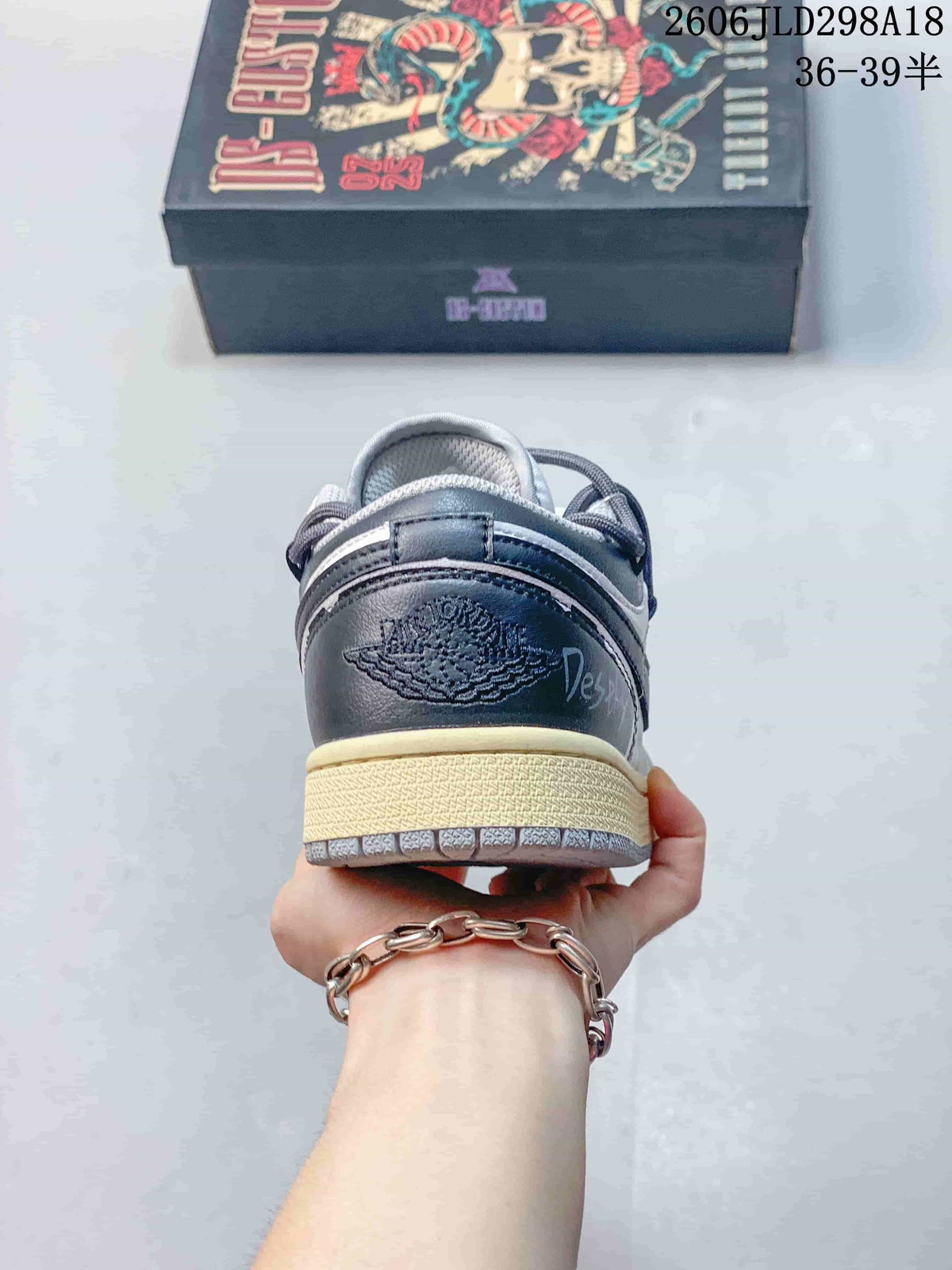 Rear view showing the dark heel panel and light-colored midsole of an Air Jordan 1 Low sneaker.