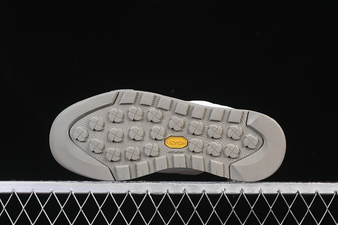 Underside showing the grey lugged outsole and Vibram branding
