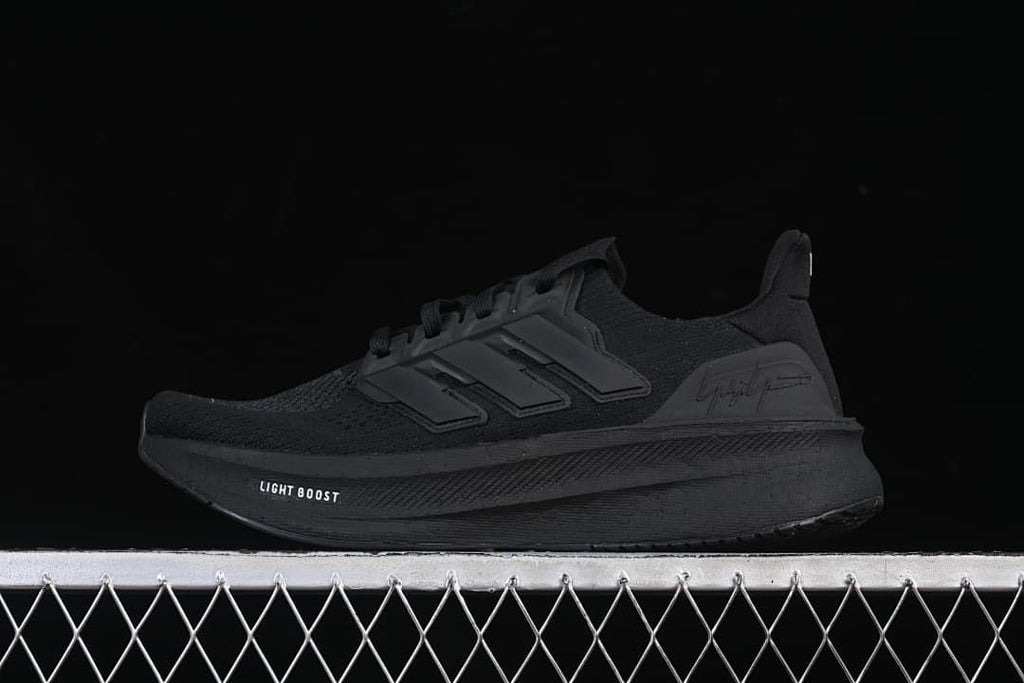 Side view of a black adidas Y-3 Ultraboost 5 shoe.