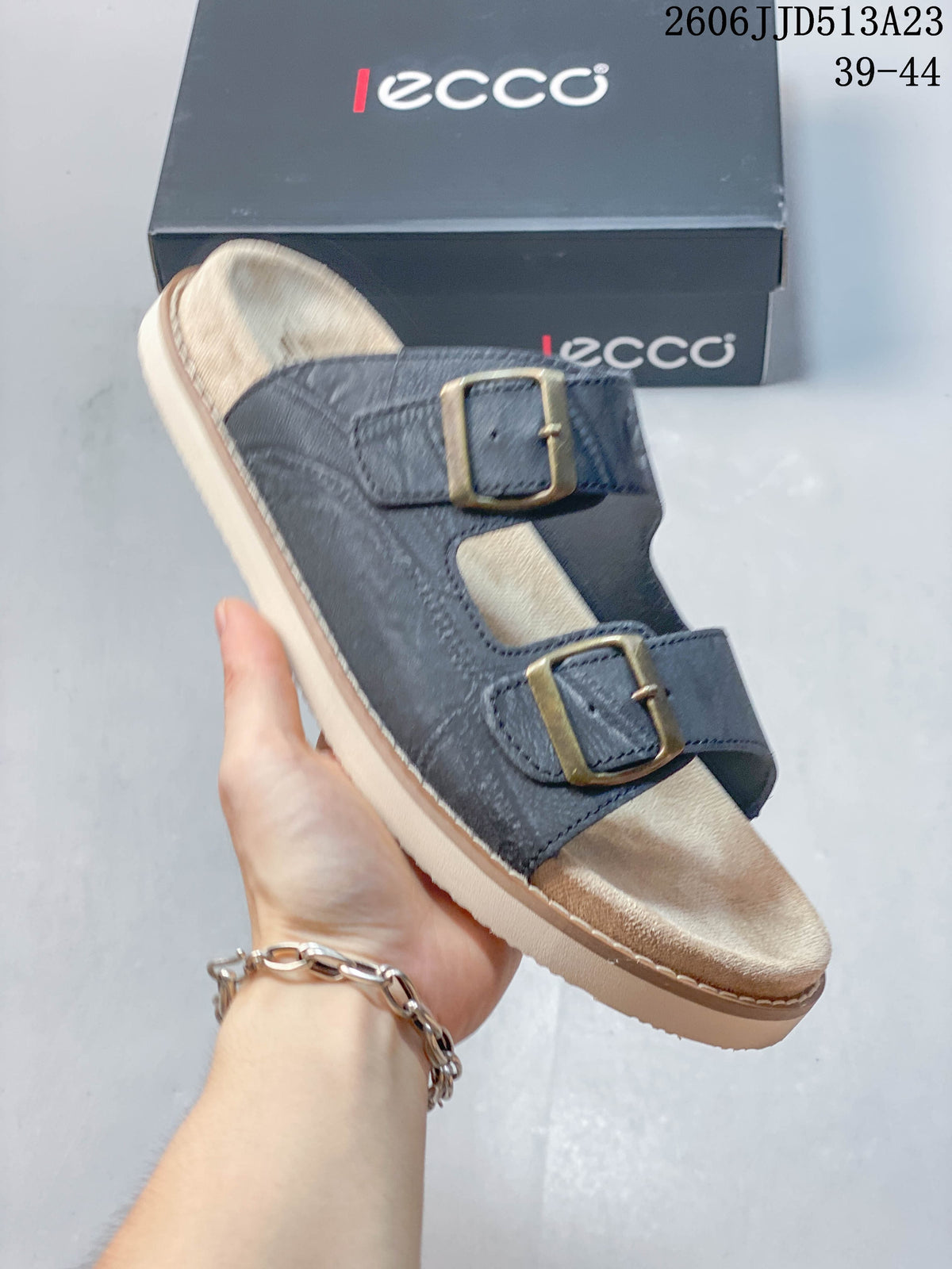 Close-up of a dark blue-gray slide sandal with buckle straps