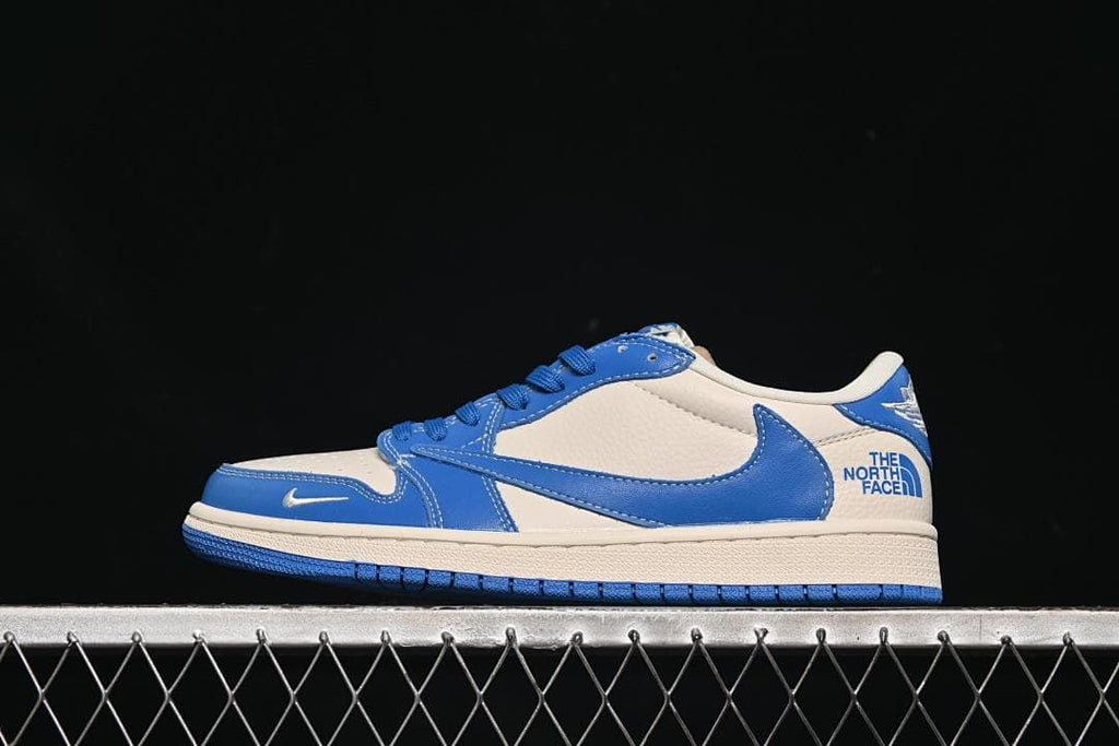 Side view of a blue and off-white low-top sneaker with The North Face lettering at the heel.