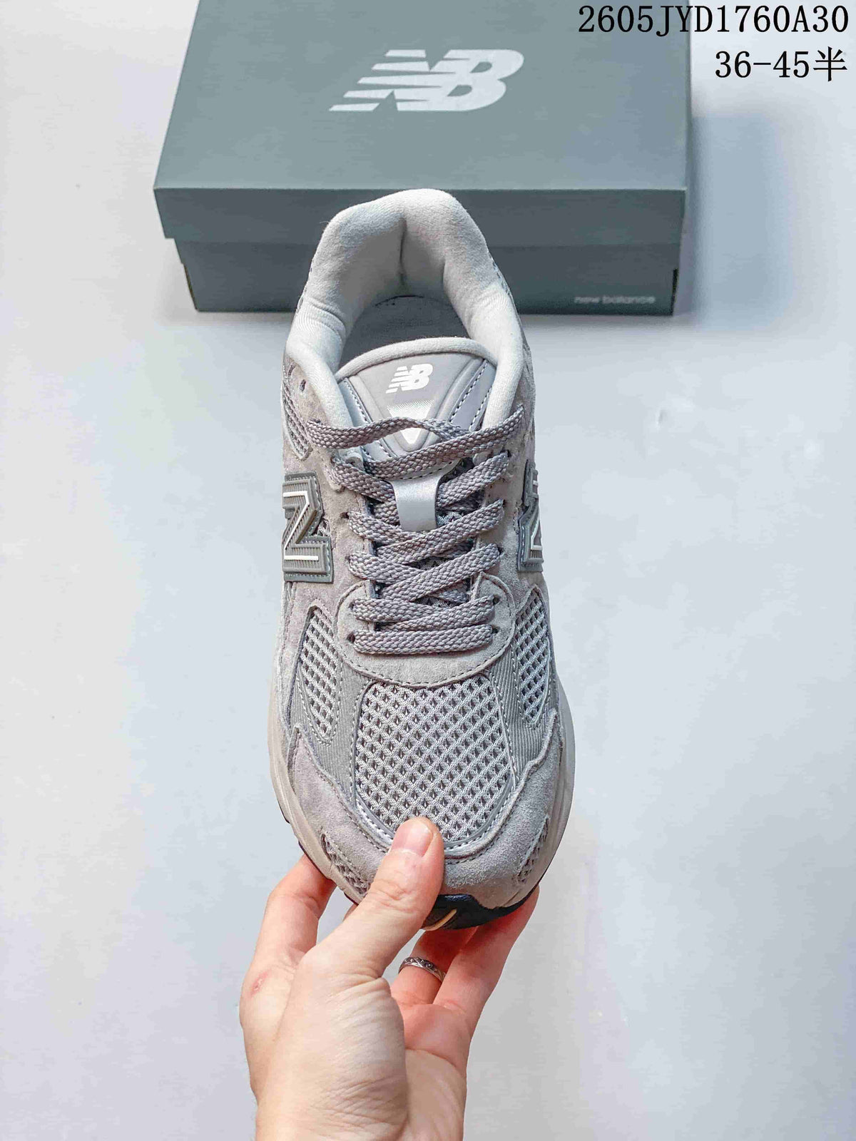 Top view of the mesh toe and laces on a grey New Balance 2010 sneaker