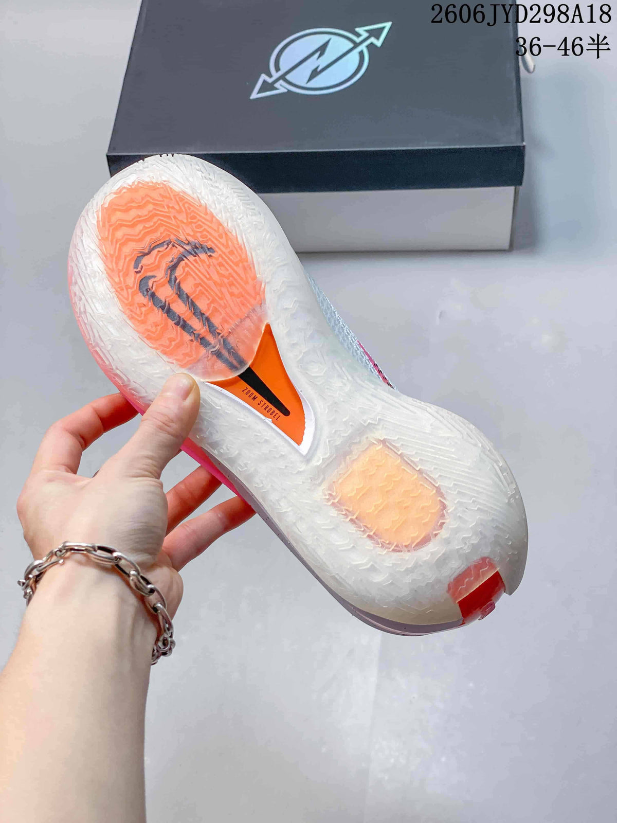 Close-up of the translucent outsole with orange sections on a Nike Air Zoom GT Cut shoe