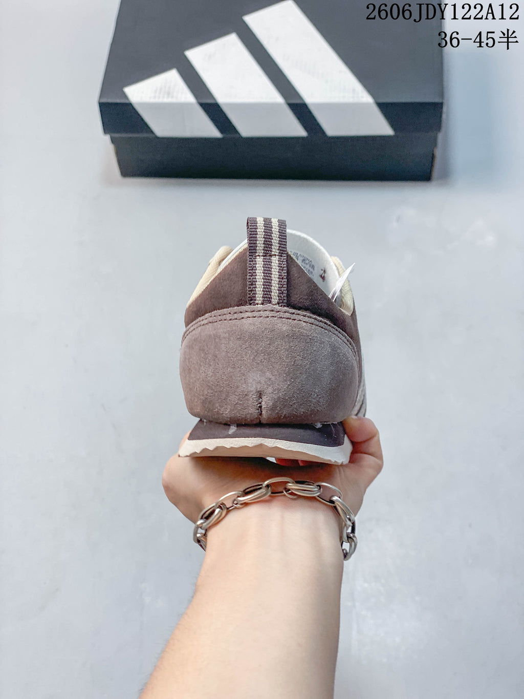 Rear view showing the heel and striped pull tab of the sneaker