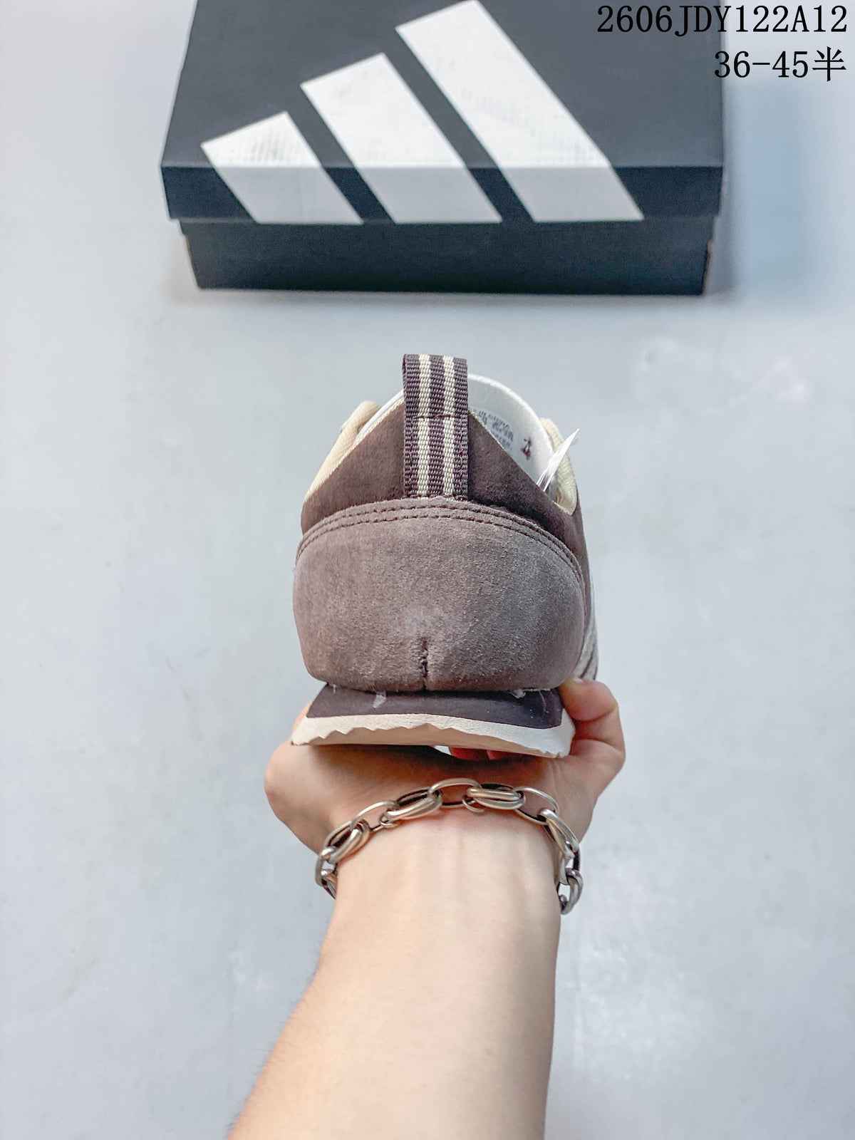 Rear view showing the heel and striped pull tab of the sneaker