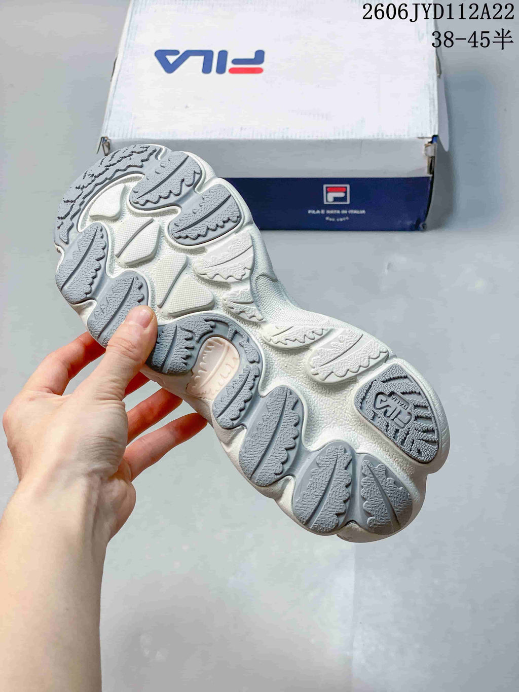 Close-up of the textured outsole on the white and gray FILA FUSION Arceus sneaker