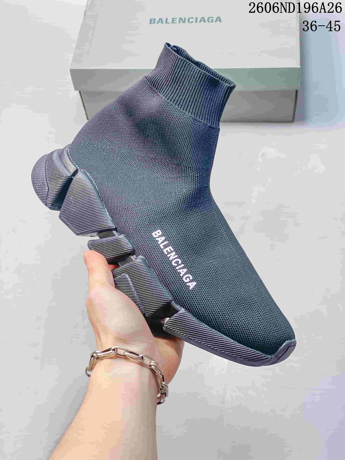 Angled side view of a charcoal grey sock-style sneaker with a high ribbed collar