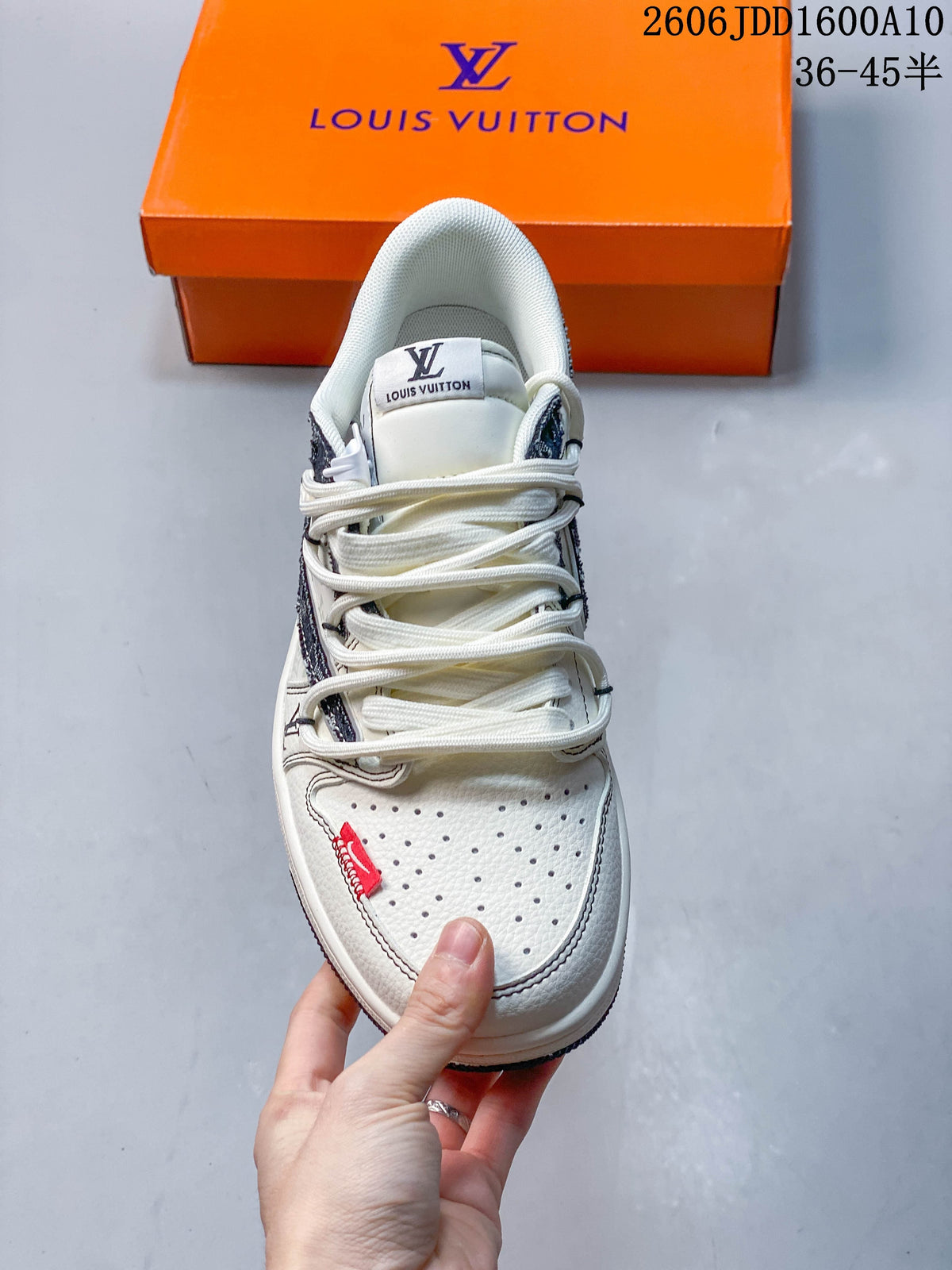 Top view showing cream laces, perforated toe panel, and red accent tab